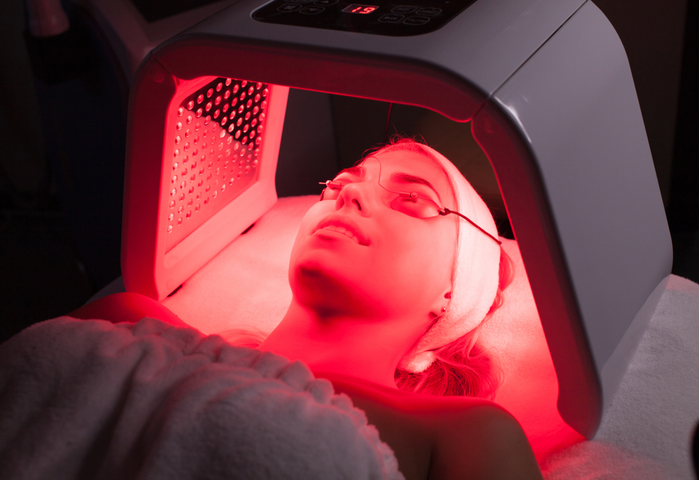 Woman receiving professional red light therapy treatment.