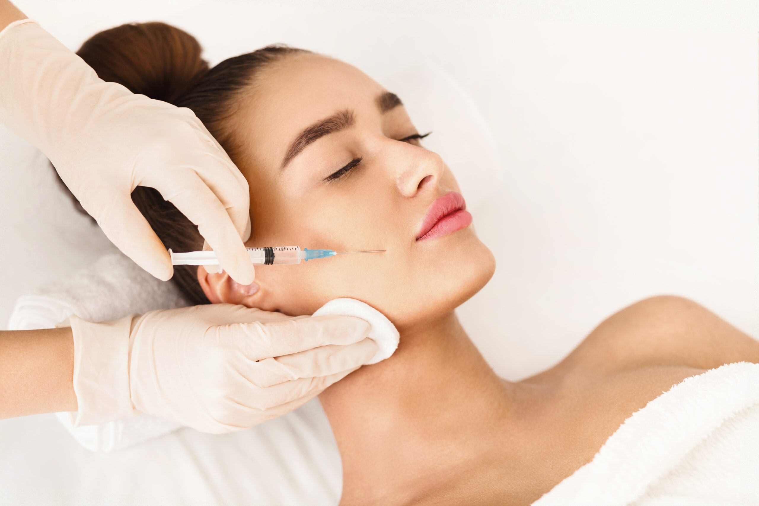 Woman receiving a Botox injection to smooth out her frown lines